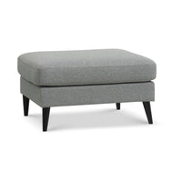 Nebraska puf fra Lexpo i lysegrå møbelstof og ben i sortbejdset eg